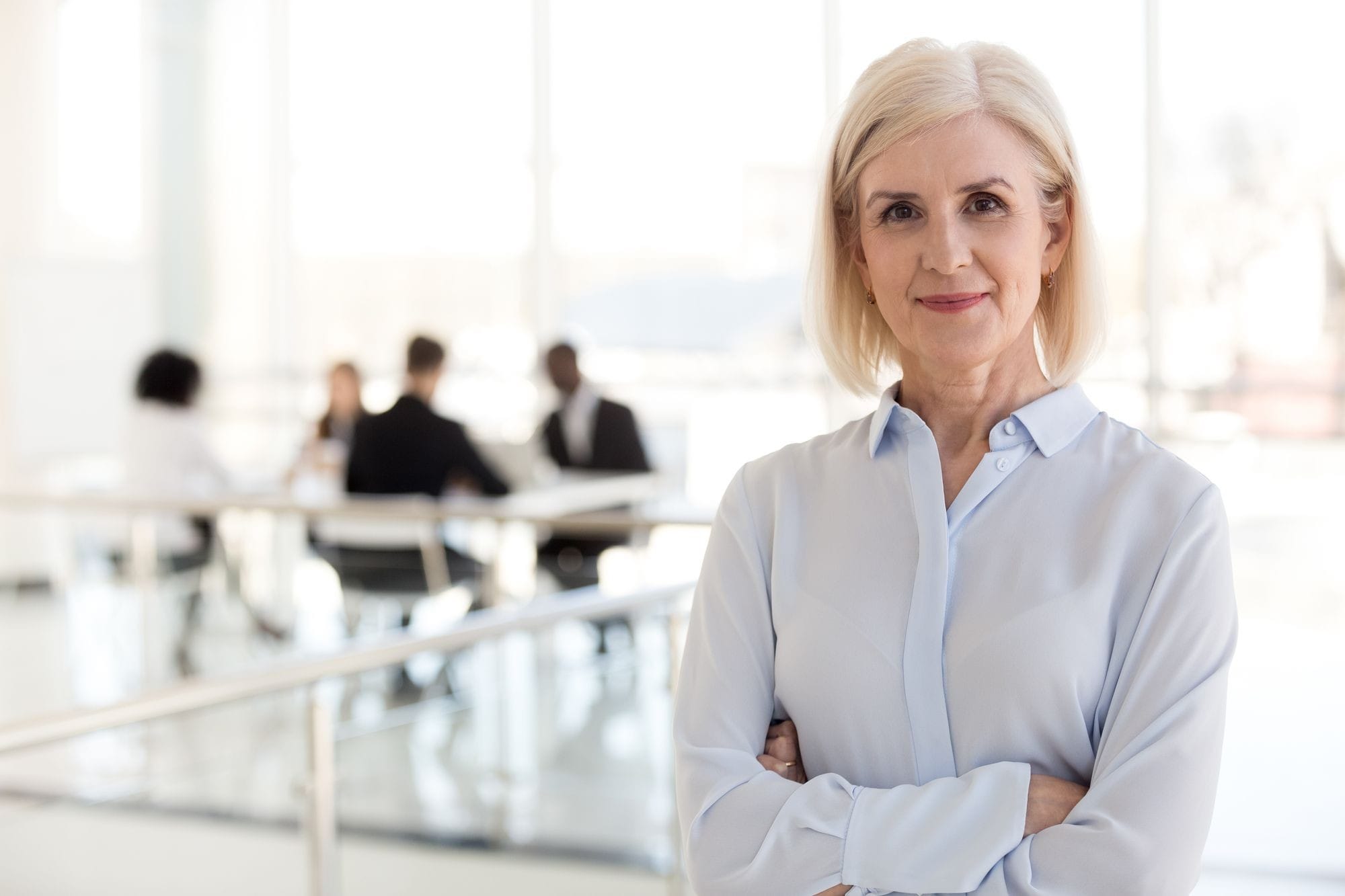 A professional woman standing in front of a group of people.